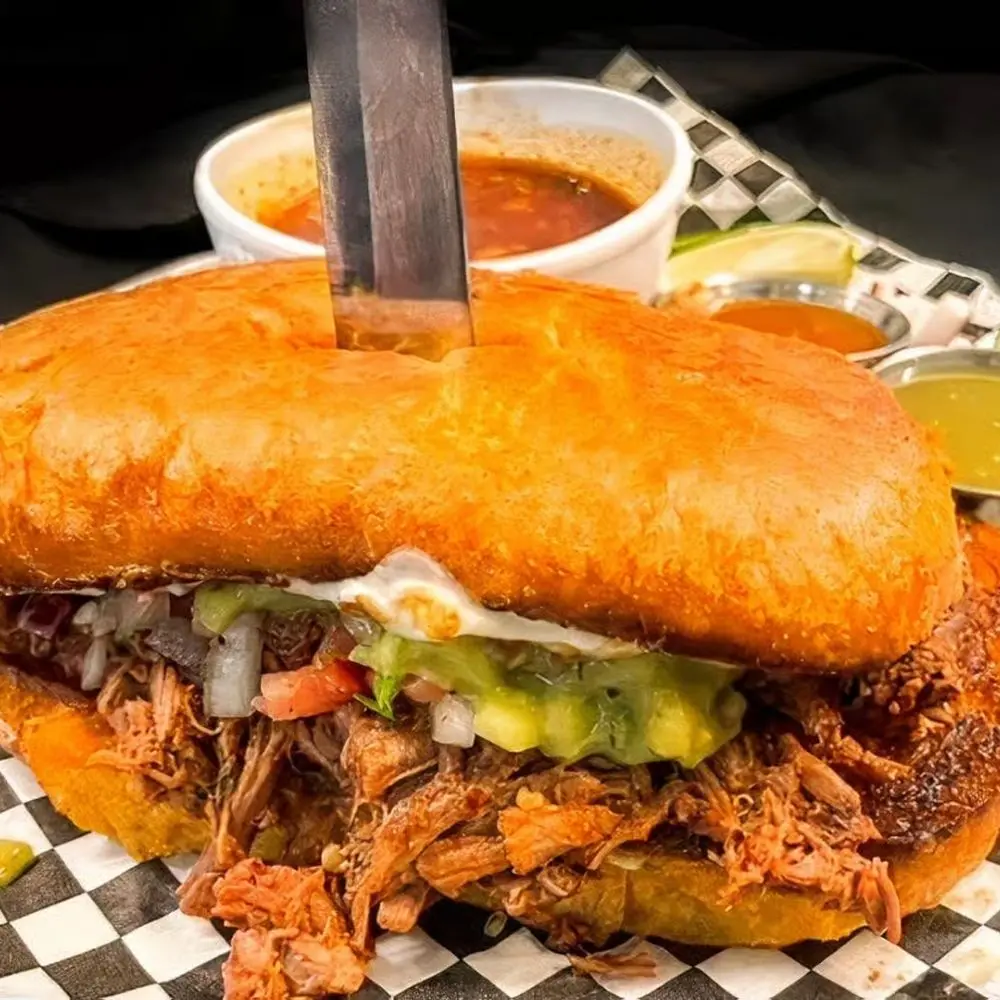 La Patrona birria torta with consomé and salsas